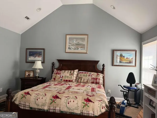 a bedroom with bed and a window