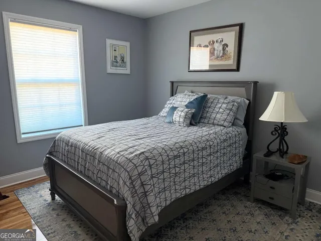 a bed sitting in a bedroom next to a window