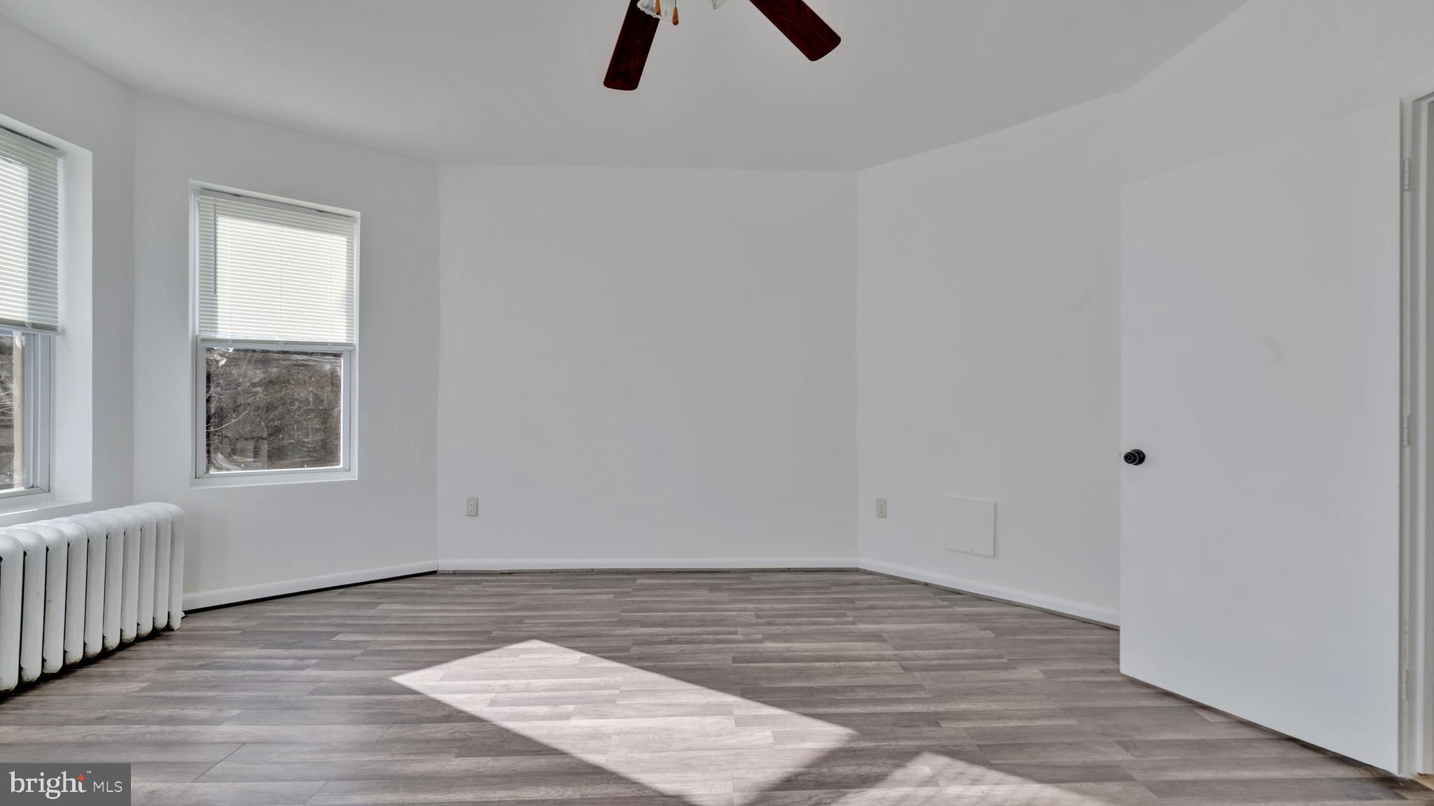 1528 E Street Southeast Washington, DC 20003 - Photo 12 of 19 wooden floor in an empty room with a window