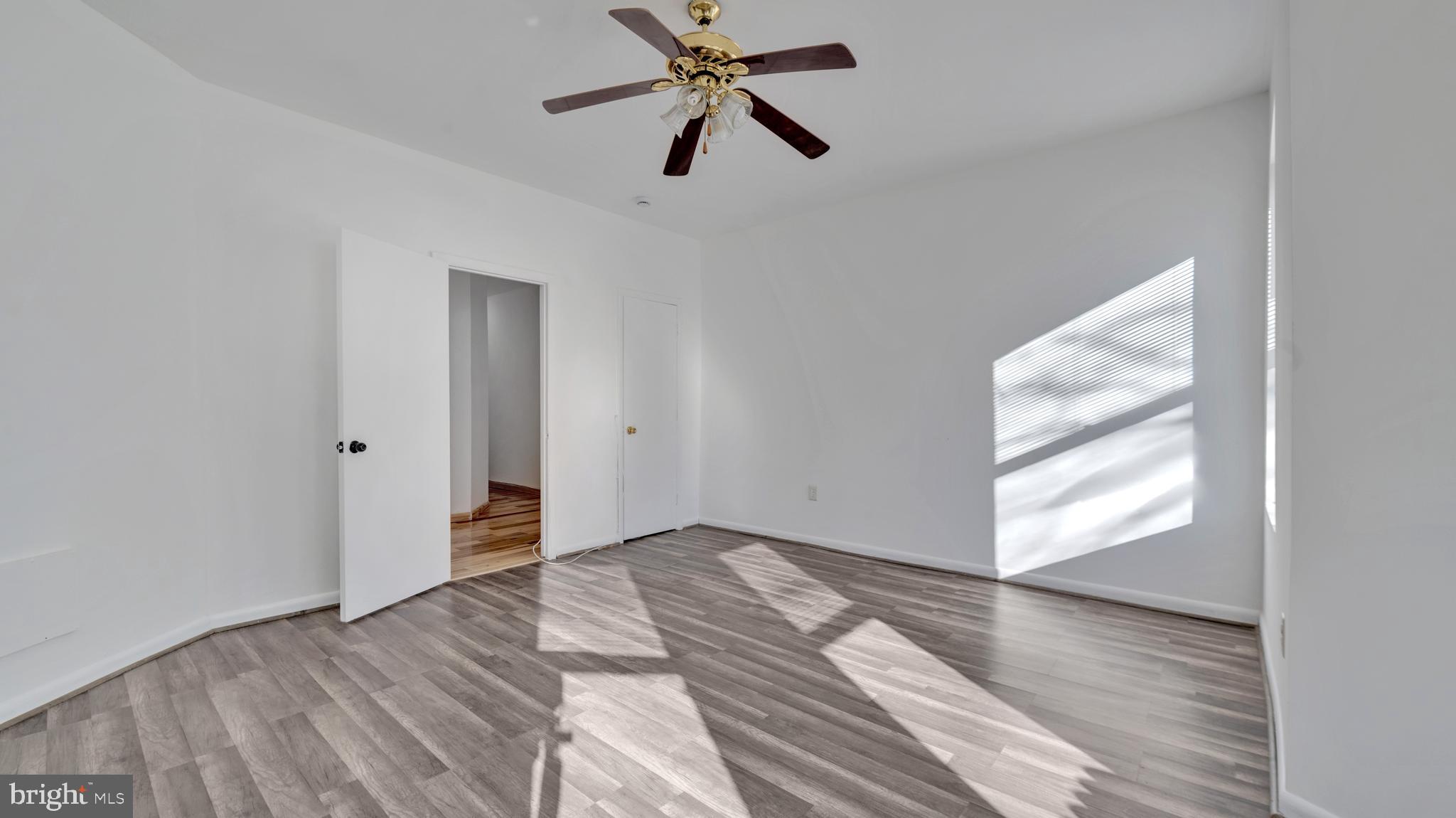 1528 E Street Southeast Washington, DC 20003 - Photo 13 of 19 wooden floor in an empty room with a window