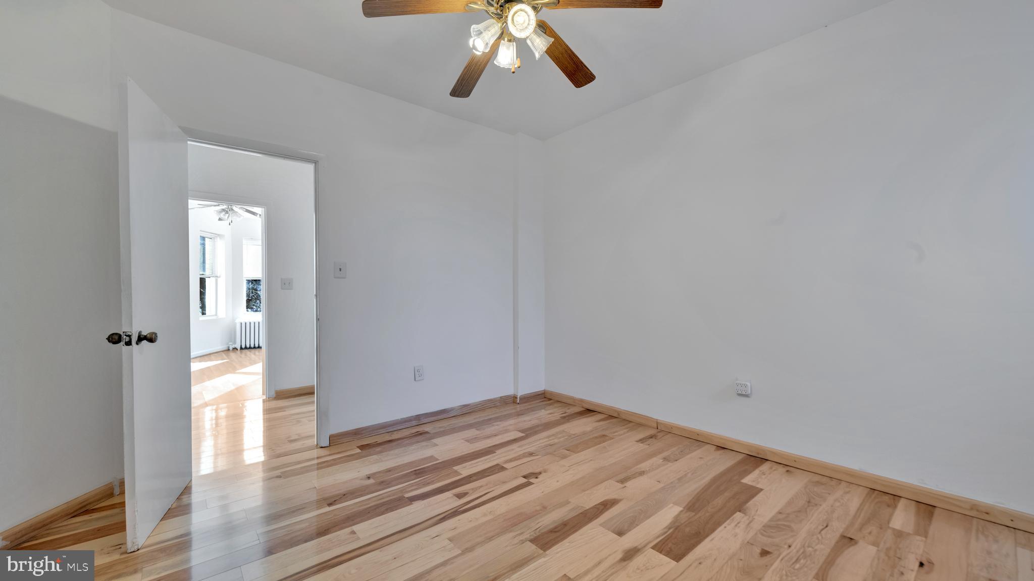 1528 E Street Southeast Washington, DC 20003 - Photo 15 of 19 a view of a room with wooden floor and white walls