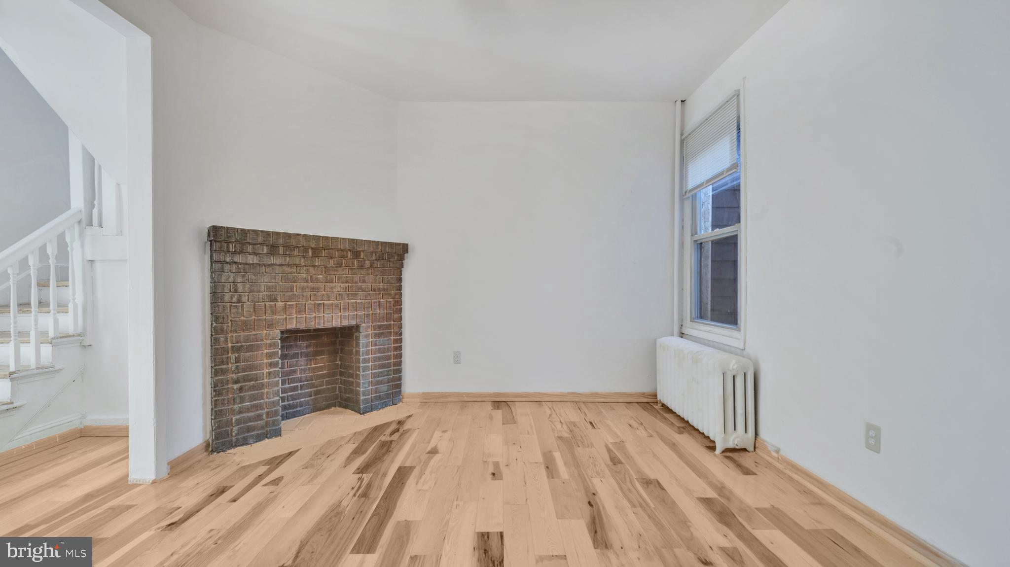 1528 E Street Southeast Washington, DC 20003 - Photo 5 of 19 a view of empty room with wooden floor and fan