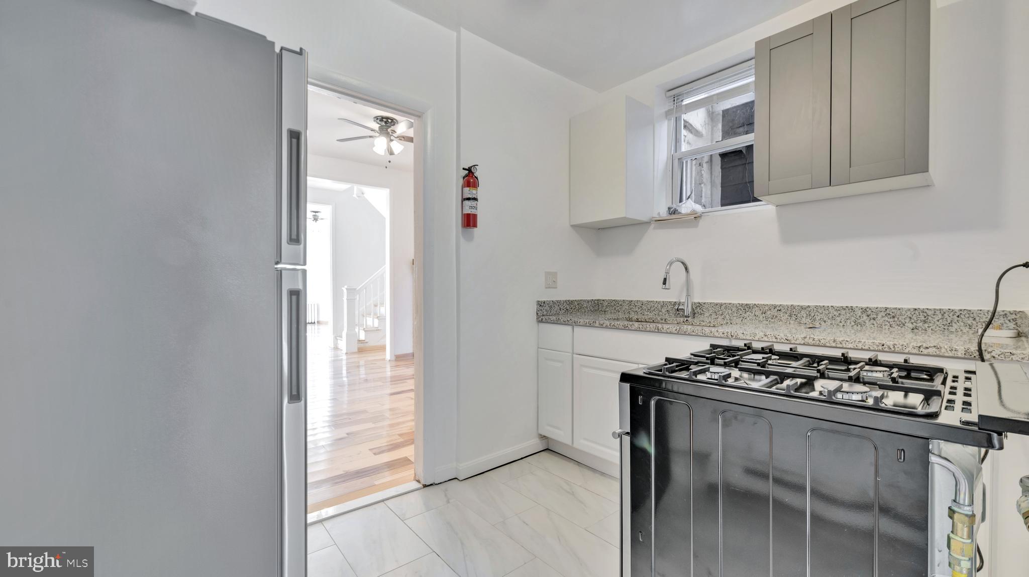 1528 E Street Southeast Washington, DC 20003 - Photo 8 of 19 a kitchen with stainless steel appliances a cabinets and a stove top oven
