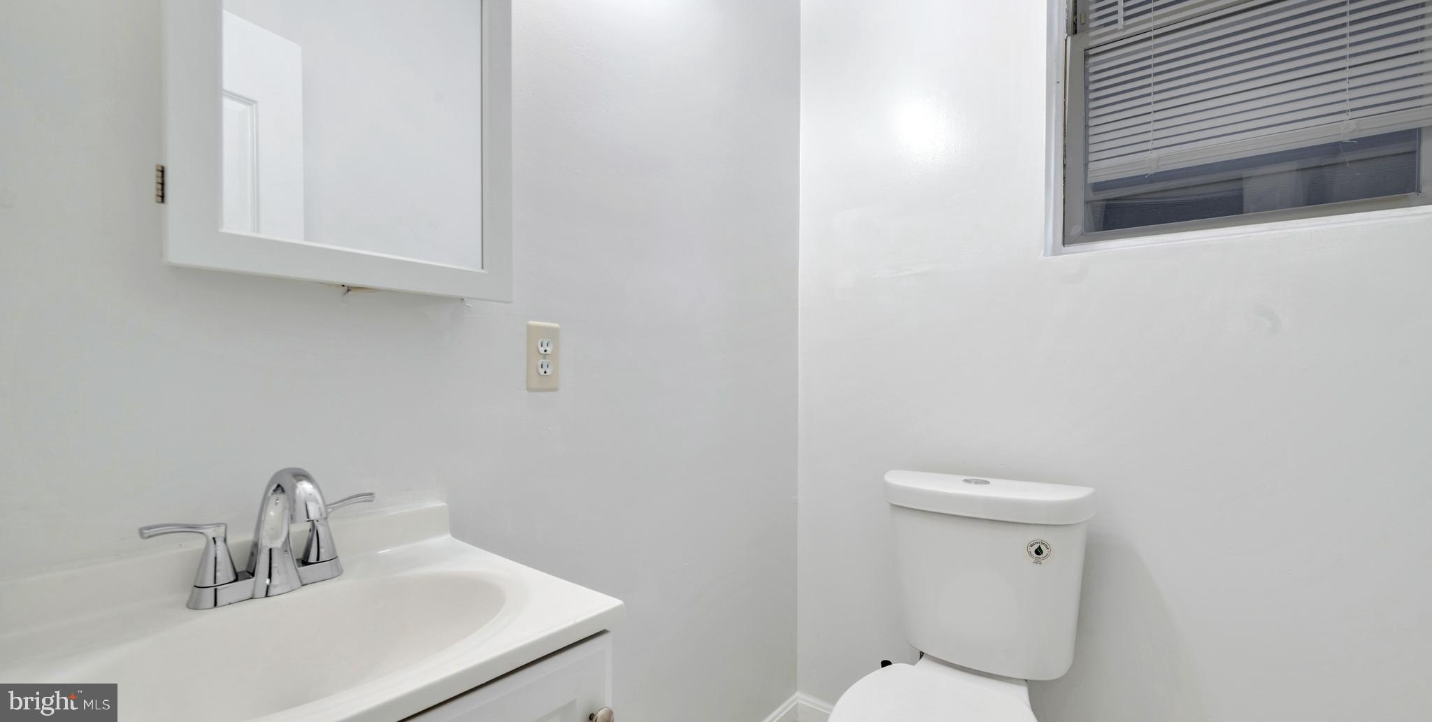 1528 E Street Southeast Washington, DC 20003 - Photo 9 of 19 a bathroom with a sink a toilet and a mirror