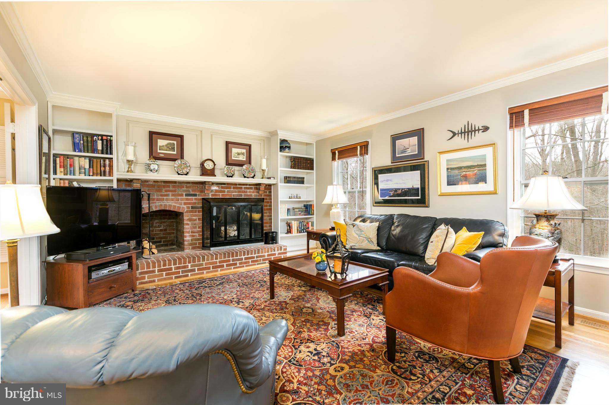 11006 Birdfoot Court Reston, VA 20191 - Photo 5 of 30 a living room with fireplace furniture and a flat screen tv