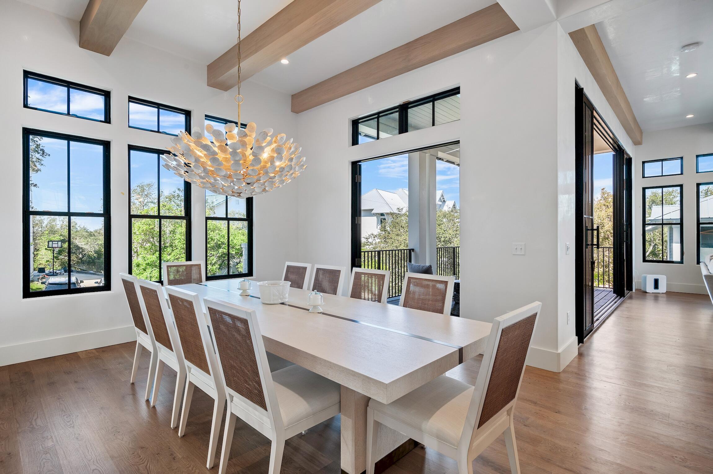 102 Bullard Road Santa Rosa Beach, FL 32459 - Photo 25 of 63 a view of a dining room with furniture a chandelier and wooden floor