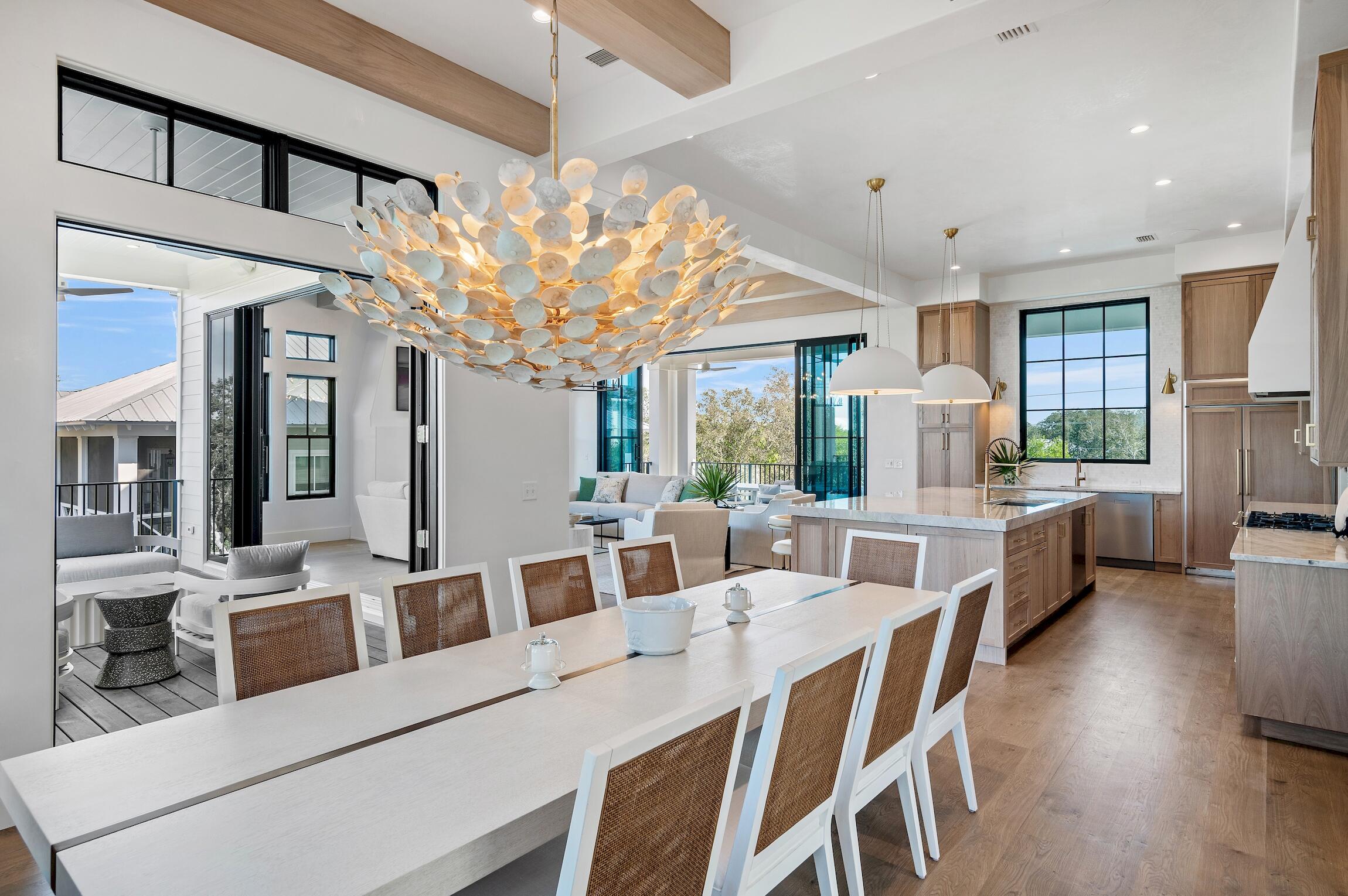 102 Bullard Road Santa Rosa Beach, FL 32459 - Photo 3 of 63 a view of a dining room with furniture a kitchen and chandelier
