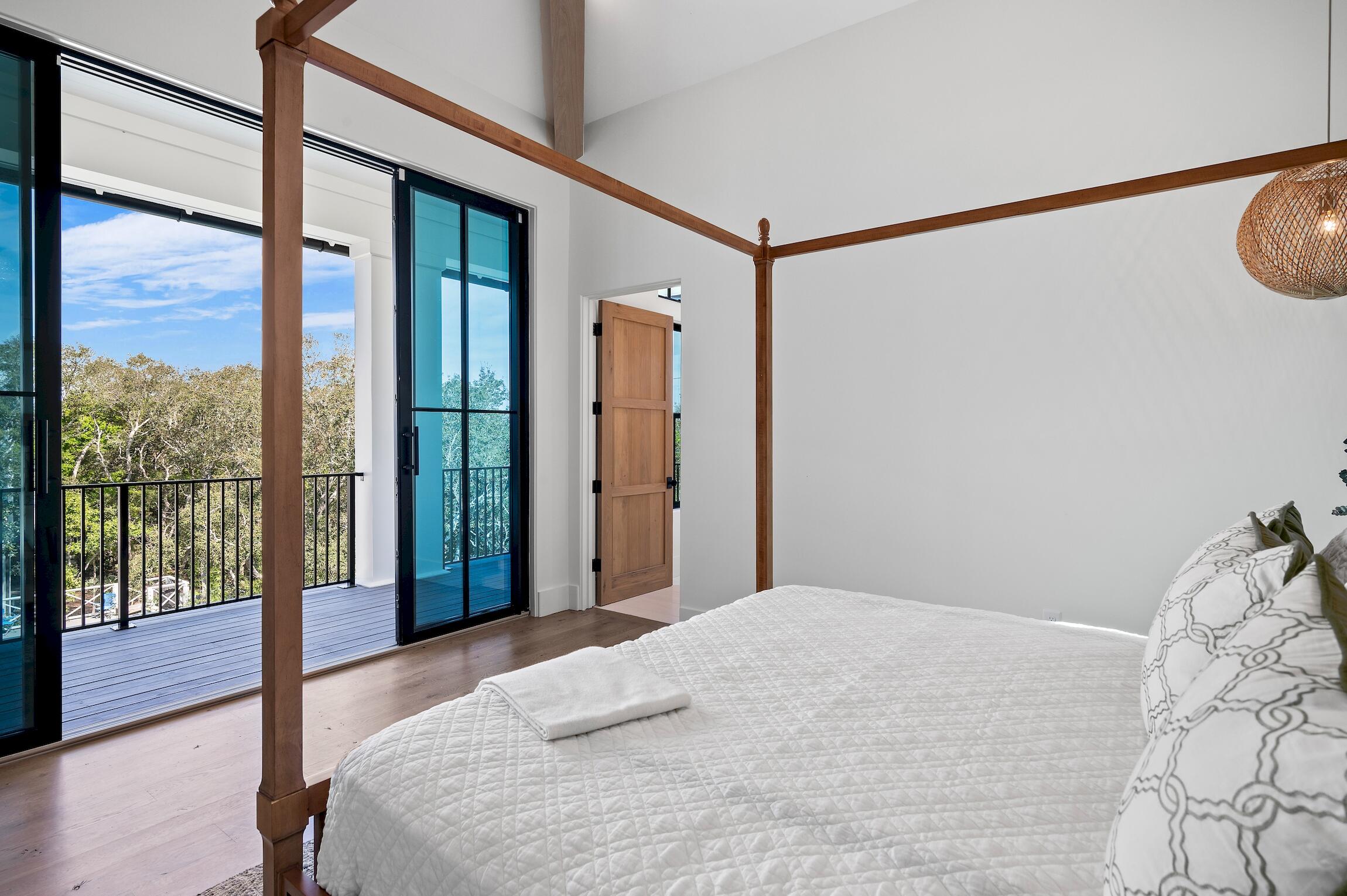 102 Bullard Road Santa Rosa Beach, FL 32459 - Photo 43 of 63 a bedroom with a large window and a bed