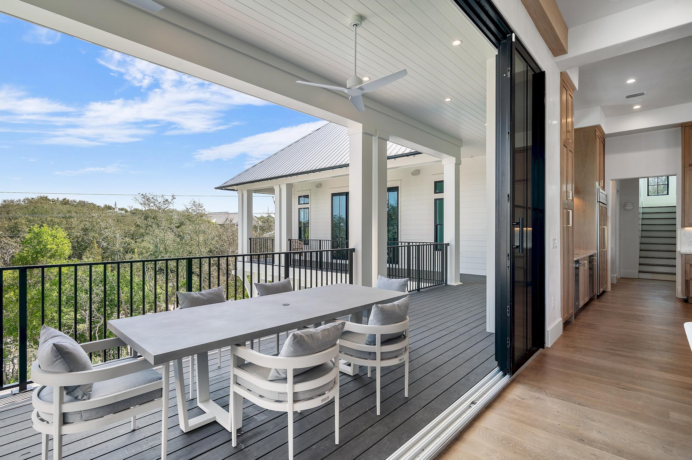 102 Bullard Road Santa Rosa Beach, FL 32459 - Photo 6 of 63 a view of a balcony with furniture and wooden floor