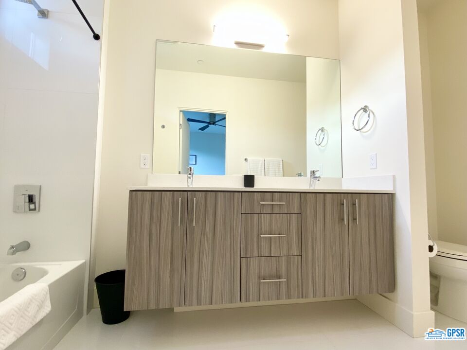 158 The River Palm Springs, CA 92262 - Photo 14 of 17 a bathroom with a bathtub a sink and a mirror