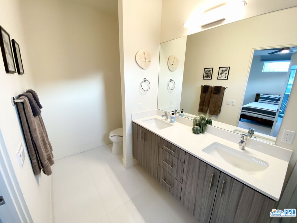 158 The River Palm Springs, CA 92262 - Photo 10 of 17 a bathroom with a double vanity sink and a mirror