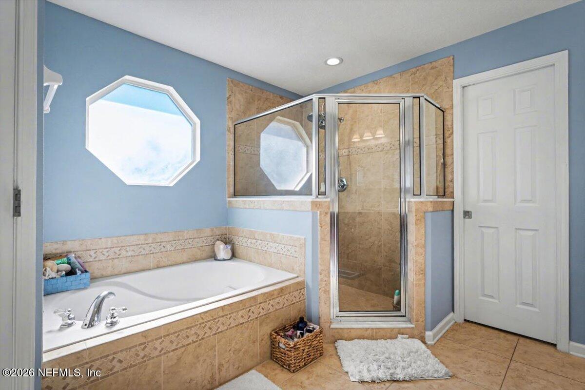 8131 Broward Cove Road Jacksonville, FL 32218 - Photo 26 of 35 a bathroom with a tub and a shower