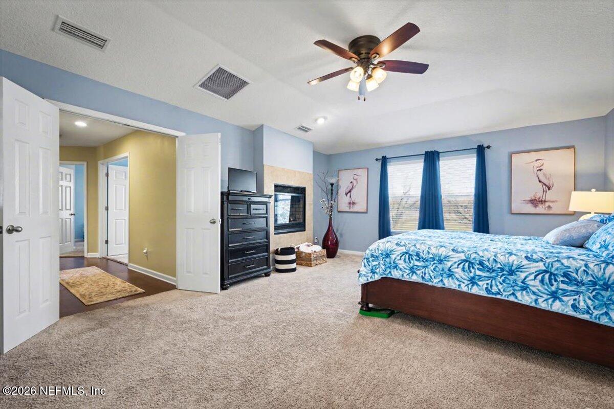 8131 Broward Cove Road Jacksonville, FL 32218 - Photo 32 of 35 a bed room with a bed and a ceiling fan