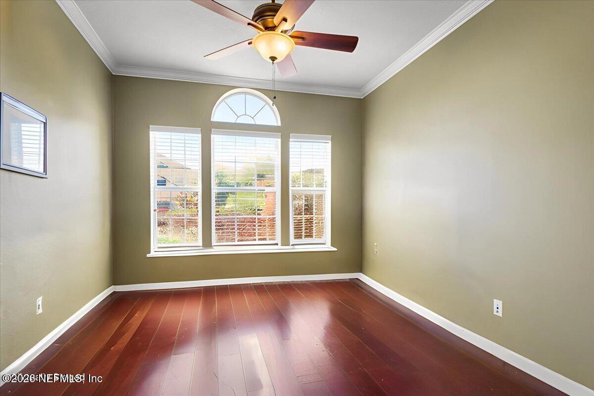 8131 Broward Cove Road Jacksonville, FL 32218 - Photo 35 of 35 an empty room with wooden floor fan and windows