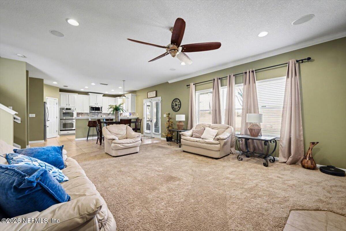 8131 Broward Cove Road Jacksonville, FL 32218 - Photo 8 of 35 a living room with furniture and a large window