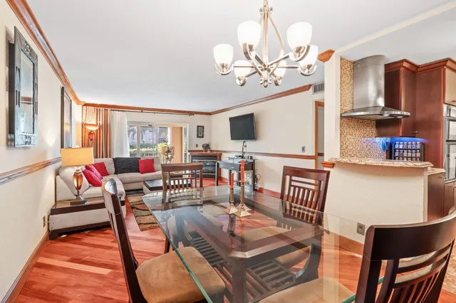 a kitchen with stainless steel appliances granite countertop a refrigerator and a stove