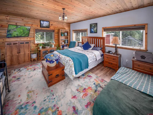 a bedroom with furniture and a chandelier