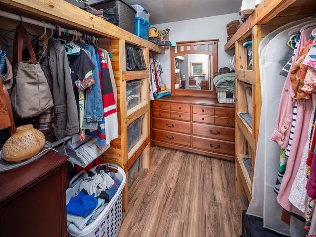 a bathroom with a granite countertop sink a toilet a mirror a vanity and bathtub