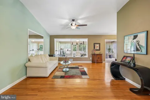 a living room with furniture a rug and white walls