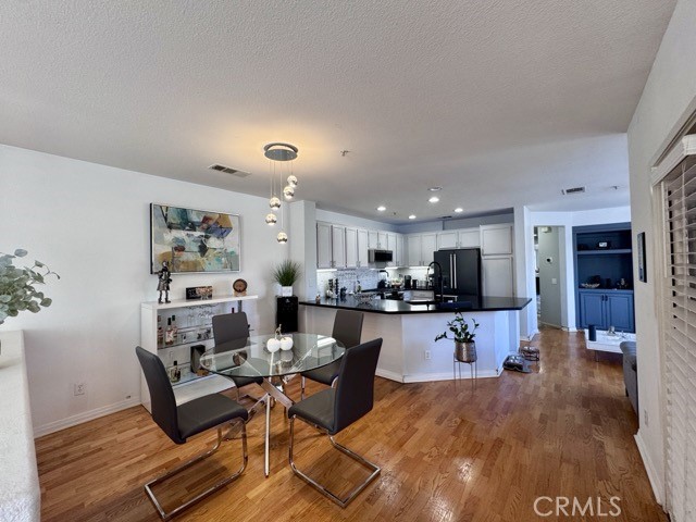 33423 Winston Way, Unit C Temecula, CA 92592 - Photo 11 of 39 a living room with furniture a flat screen tv and kitchen view