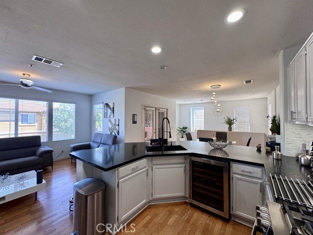 33423 Winston Way, Unit C Temecula, CA 92592 - Photo 16 of 39 a kitchen with granite countertop a sink cabinets and wooden floor