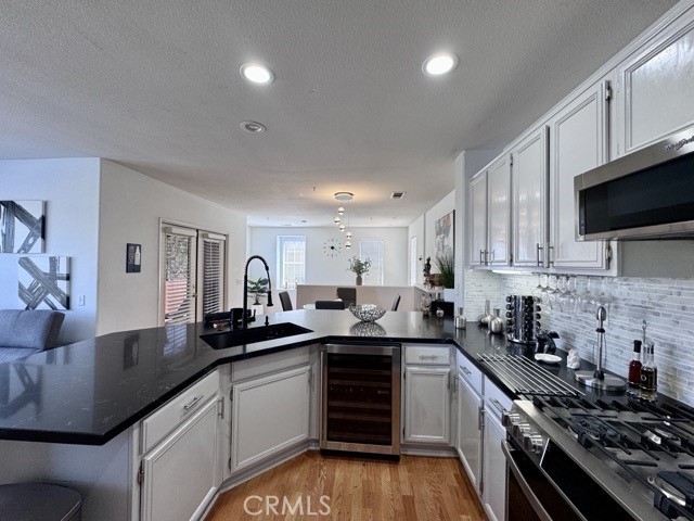 33423 Winston Way, Unit C Temecula, CA 92592 - Photo 17 of 39 a kitchen with granite countertop a sink a stove and cabinets