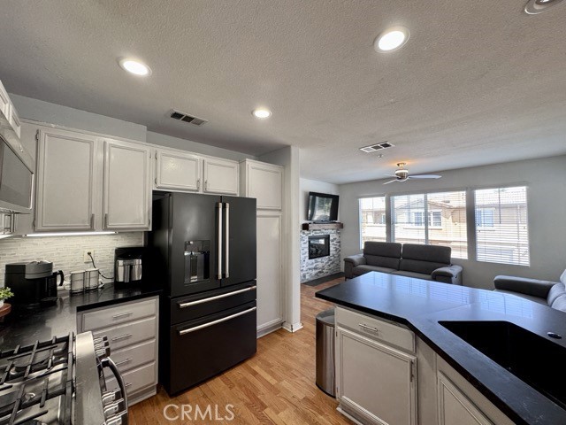 33423 Winston Way, Unit C Temecula, CA 92592 - Photo 18 of 39 a kitchen with a refrigerator a sink a stove and cabinets