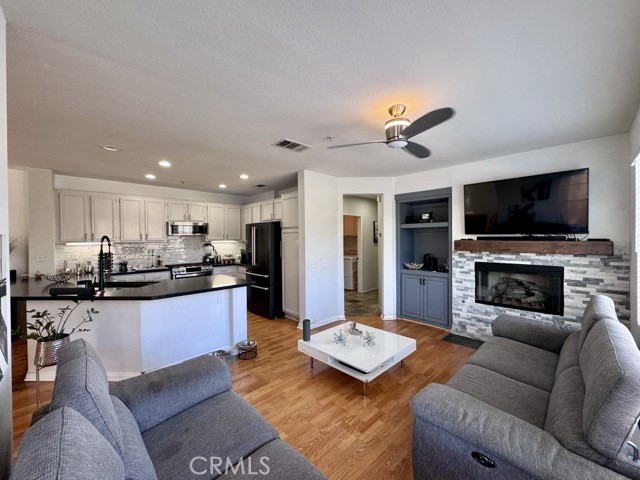 33423 Winston Way, Unit C Temecula, CA 92592 - Photo 20 of 39 a living room with furniture flat screen tv and a fireplace