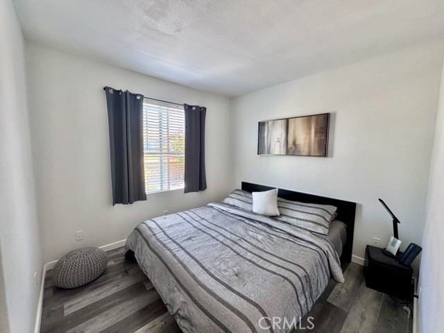 33423 Winston Way, Unit C Temecula, CA 92592 - Photo 24 of 39 a bedroom with a bed and wooden floor