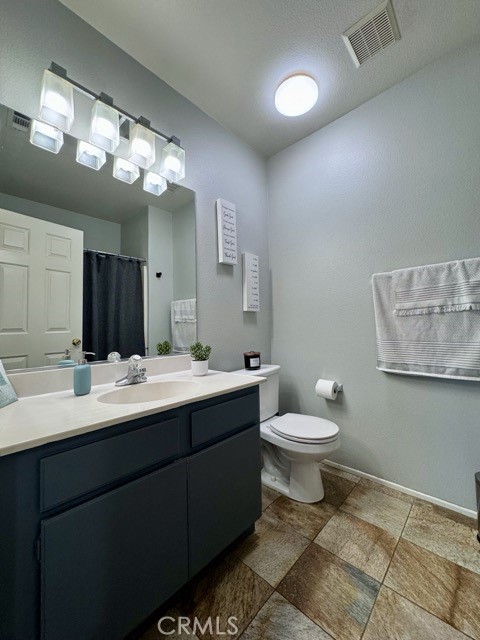 33423 Winston Way, Unit C Temecula, CA 92592 - Photo 26 of 39 a bathroom with a toilet sink and mirror