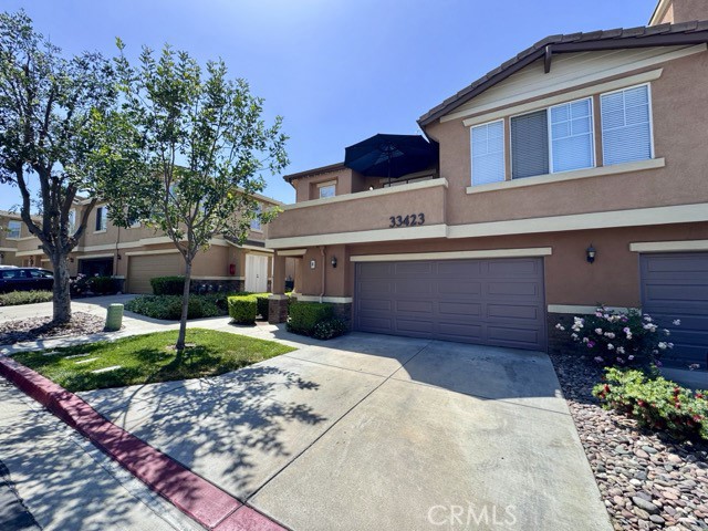 33423 Winston Way, Unit C Temecula, CA 92592 - Photo 4 of 39 a view of a house with a yard and garage