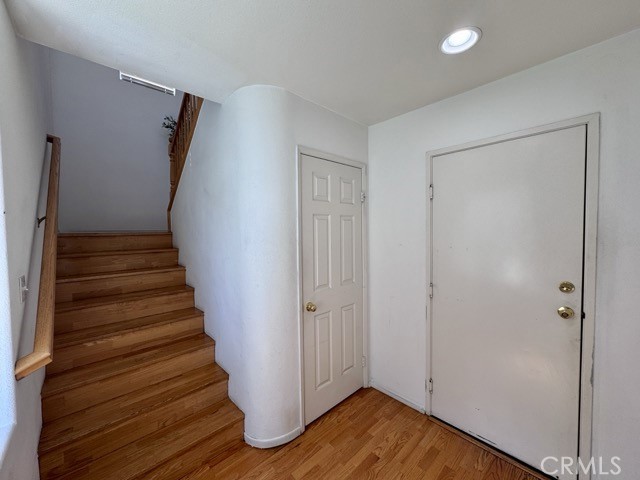 33423 Winston Way, Unit C Temecula, CA 92592 - Photo 8 of 39 a view of a hallway with wooden floor and entryway