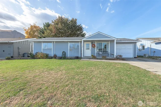 a front view of house with yard and green space