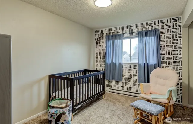 a bedroom with furniture and a window
