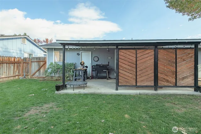a view of a chair and table in the back yard