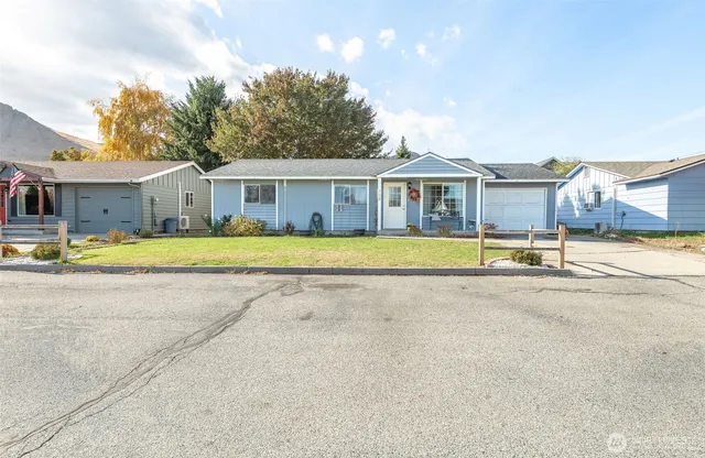 a view of a house with swimming pool and a yard