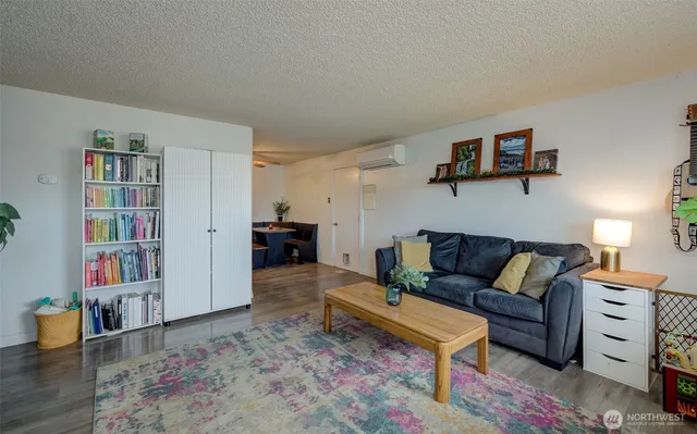 a living room with furniture and a book shelf