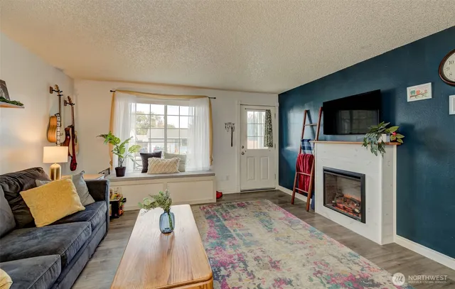 a living room with furniture and a fireplace