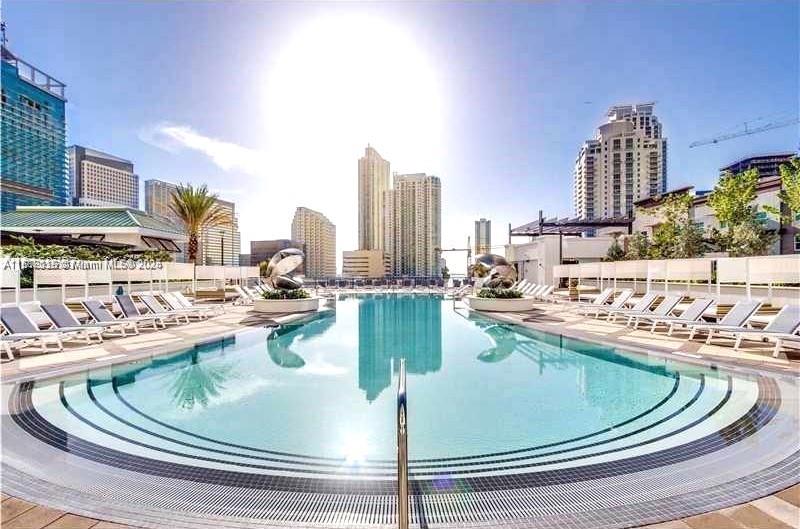 999 Southwest 1st Avenue, Unit 2115 Miami, FL 33130 - Photo 14 of 27 a view of a swimming pool with outdoor seating