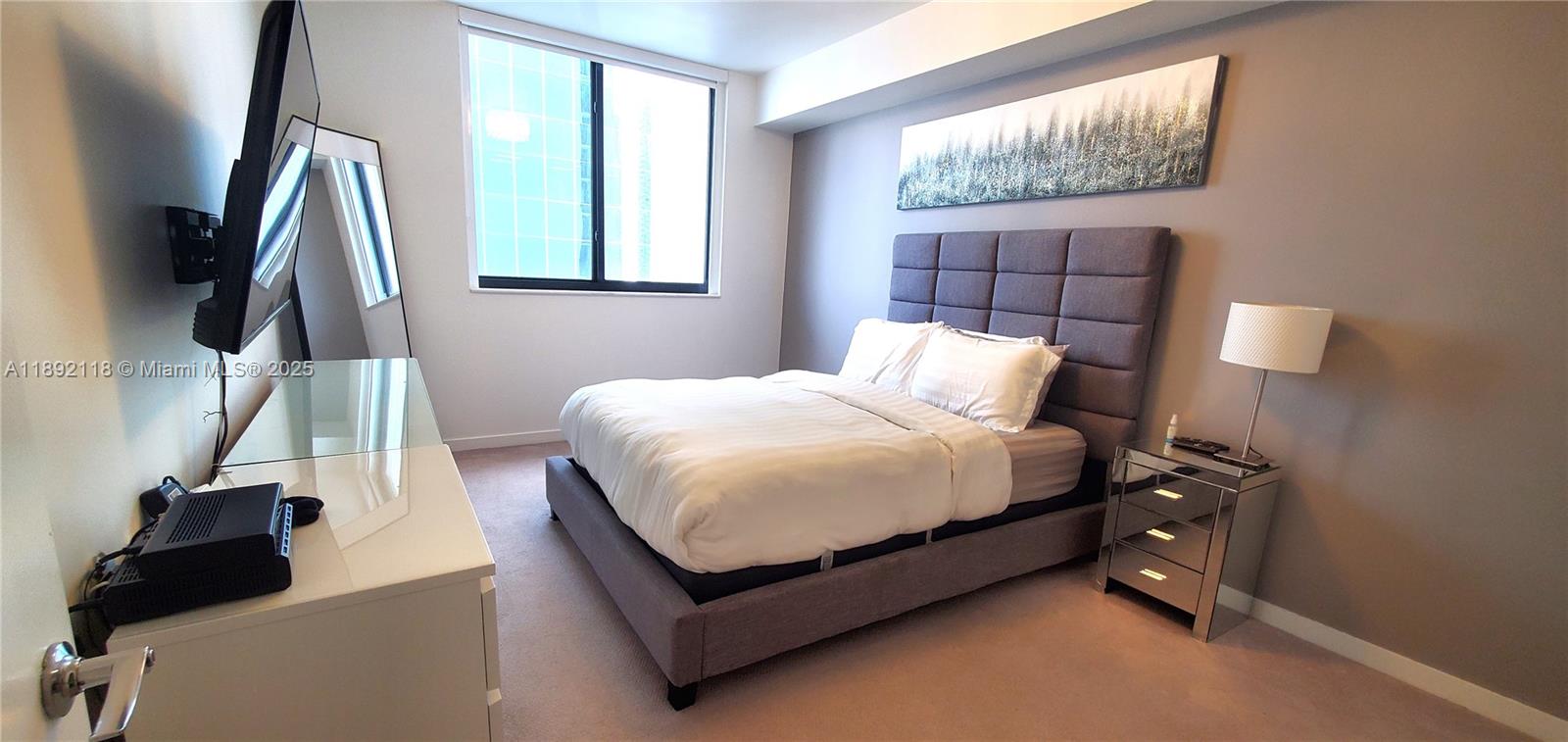 999 Southwest 1st Avenue, Unit 2115 Miami, FL 33130 - Photo 5 of 27 a bedroom with a bed and a window