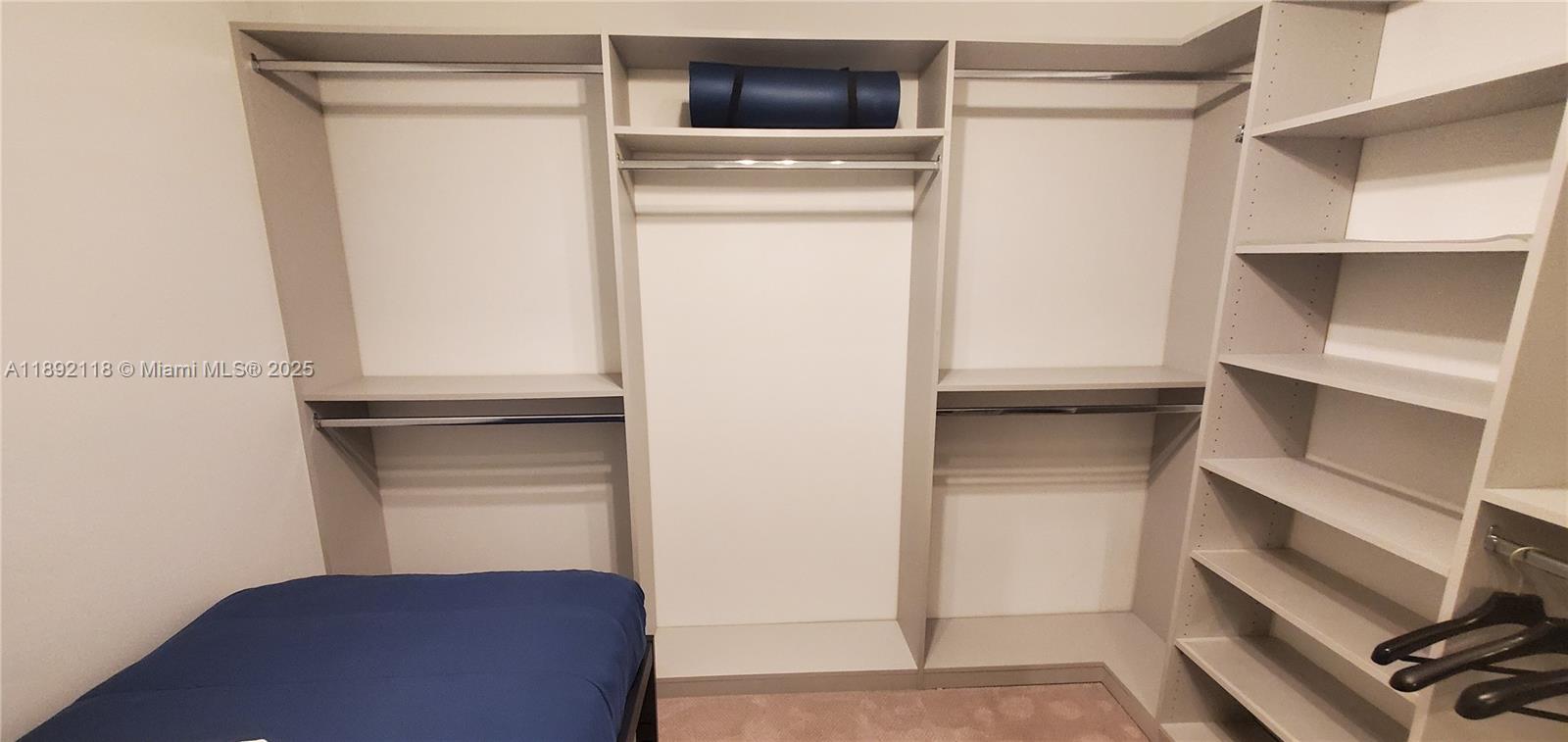 999 Southwest 1st Avenue, Unit 2115 Miami, FL 33130 - Photo 6 of 27 a view of walk in closet with empty racks