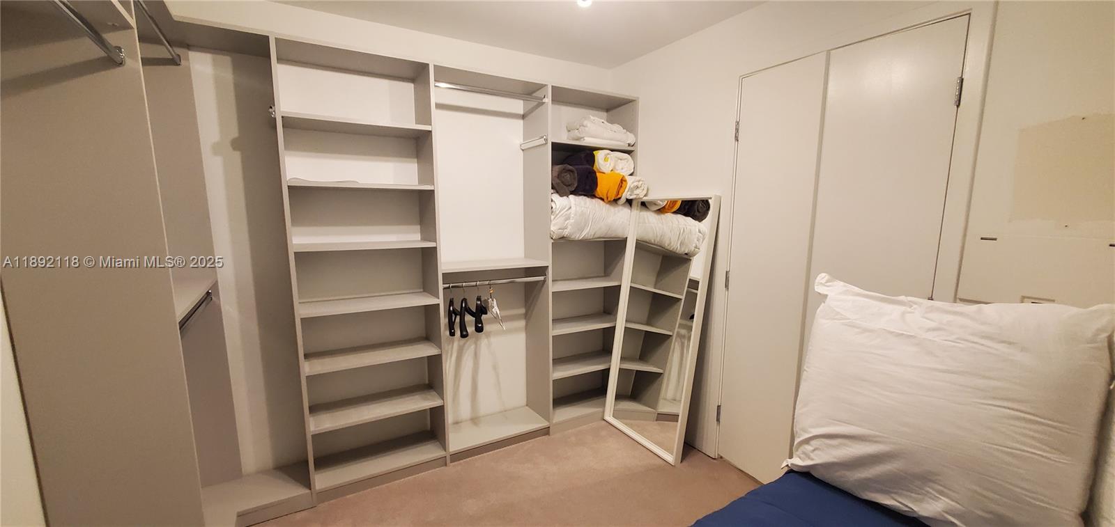 999 Southwest 1st Avenue, Unit 2115 Miami, FL 33130 - Photo 7 of 27 a view of bedroom with wooden floor and closet