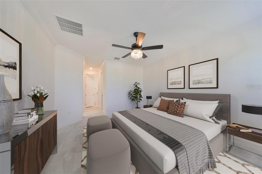 933 Signet Drive Apollo Beach, FL 33572 - Photo 17 of 66 a bedroom with a bed and a chandelier