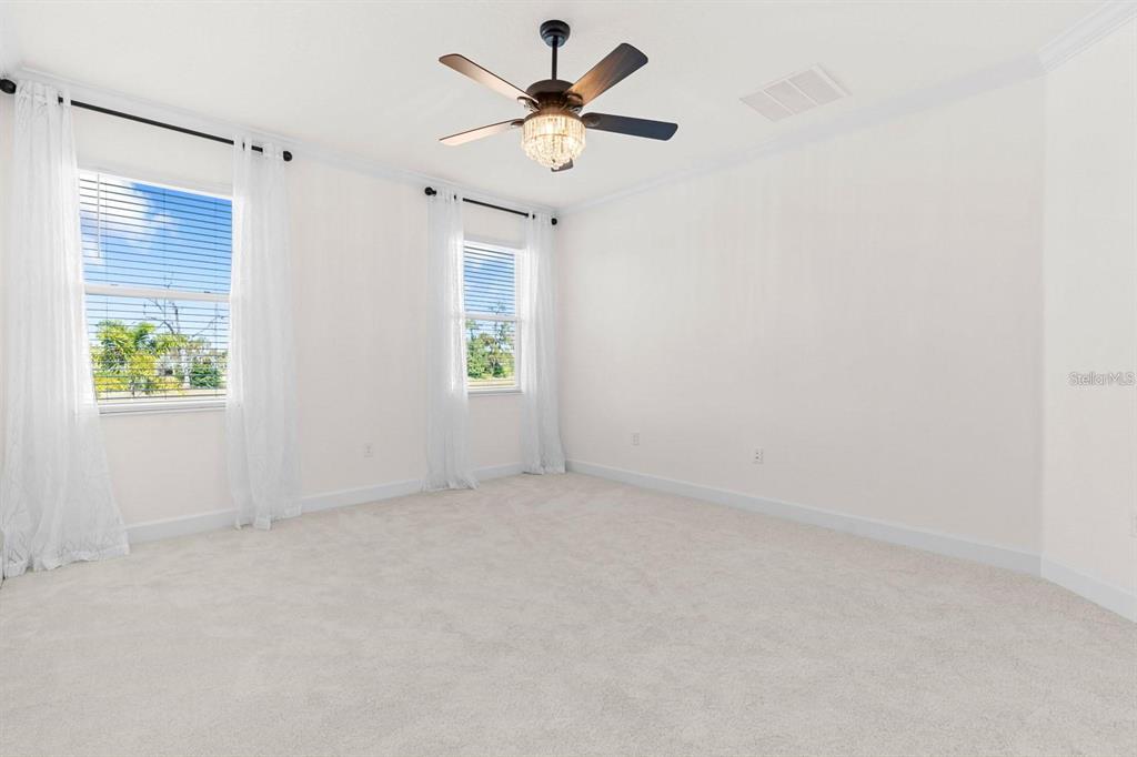 933 Signet Drive Apollo Beach, FL 33572 - Photo 18 of 66 an empty room with windows and fan