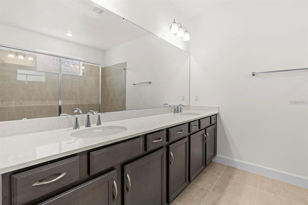 933 Signet Drive Apollo Beach, FL 33572 - Photo 20 of 66 a bathroom with double sink and a mirror