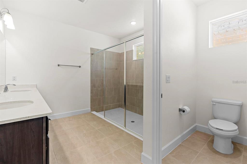 933 Signet Drive Apollo Beach, FL 33572 - Photo 21 of 66 a bathroom with a sink toilet and shower