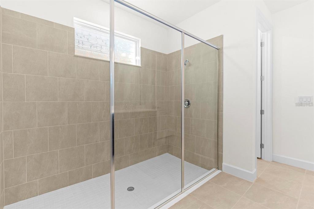 933 Signet Drive Apollo Beach, FL 33572 - Photo 22 of 66 a bathroom with a shower and a bathtub