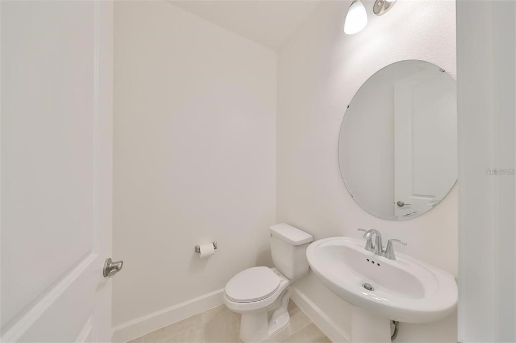933 Signet Drive Apollo Beach, FL 33572 - Photo 24 of 66 a bathroom with a toilet sink and mirror