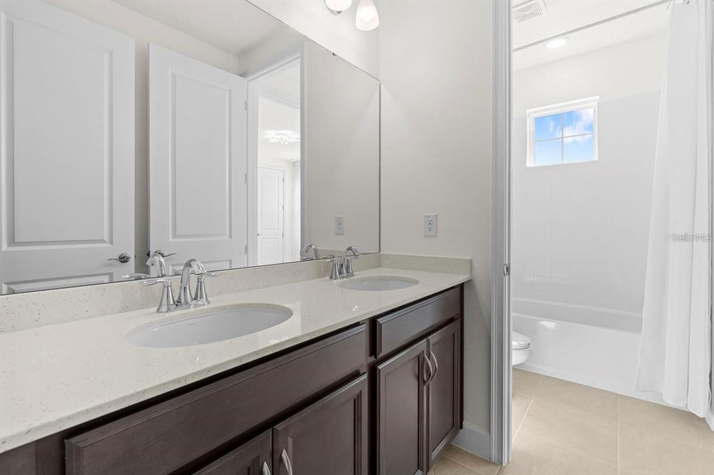 933 Signet Drive Apollo Beach, FL 33572 - Photo 31 of 66 a bathroom with a sink and a mirror