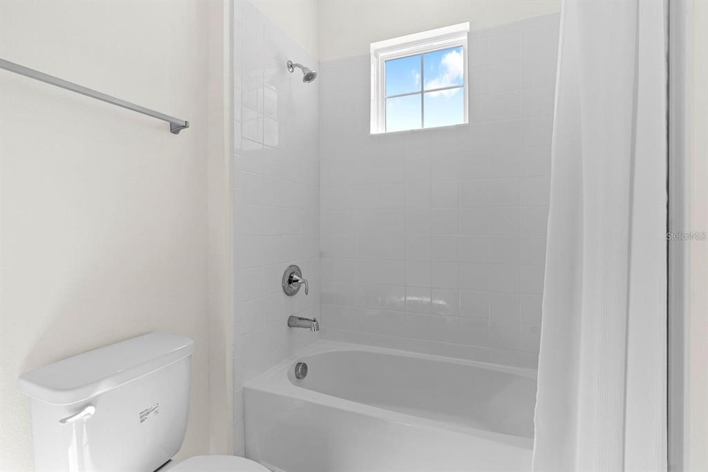 933 Signet Drive Apollo Beach, FL 33572 - Photo 32 of 66 a bathroom with a bathtub and a shower